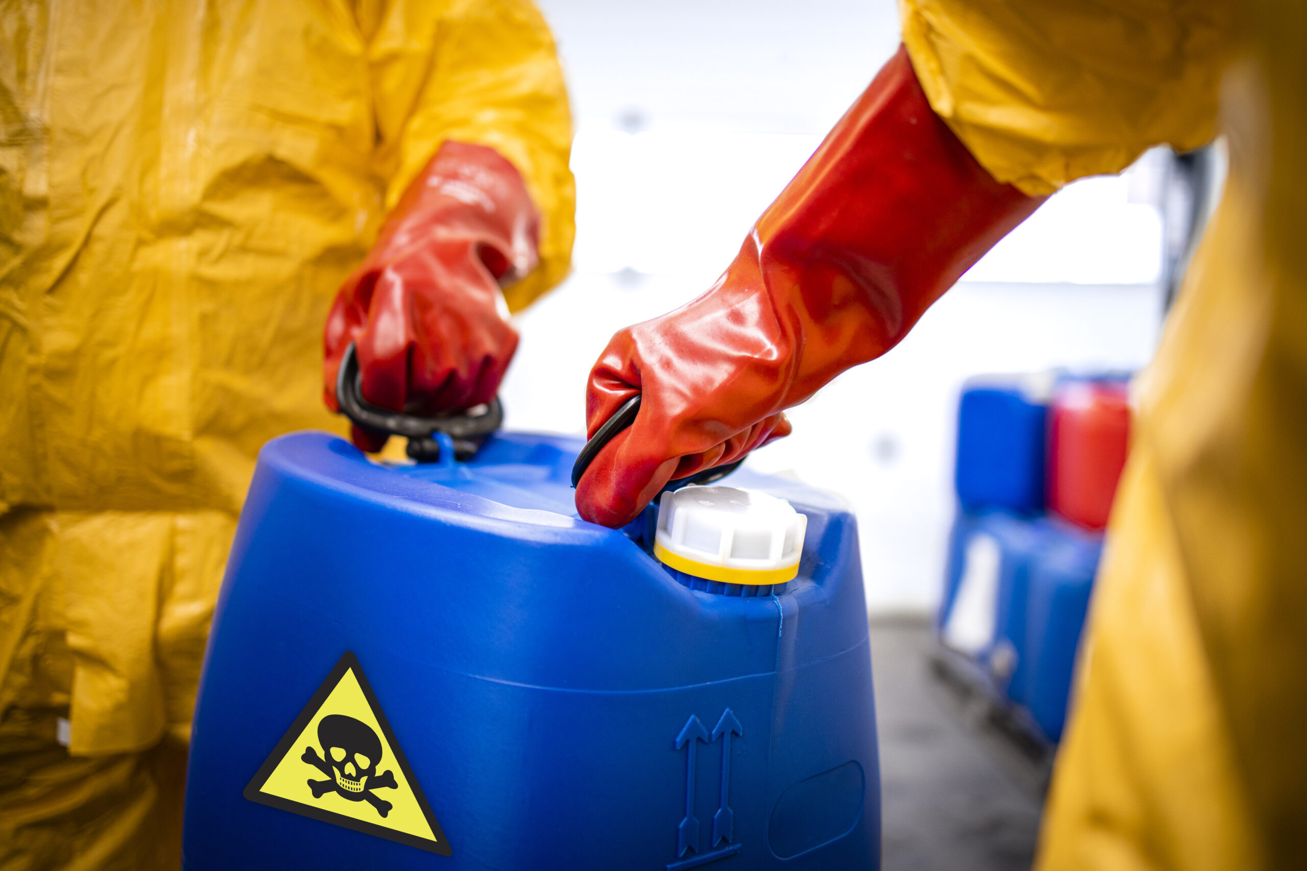 Protective gloves handling a chemical container